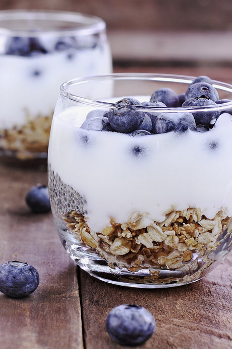 Blueberries, Rolled Oats, and Sahara Blueberry Kefir in a glass cup.